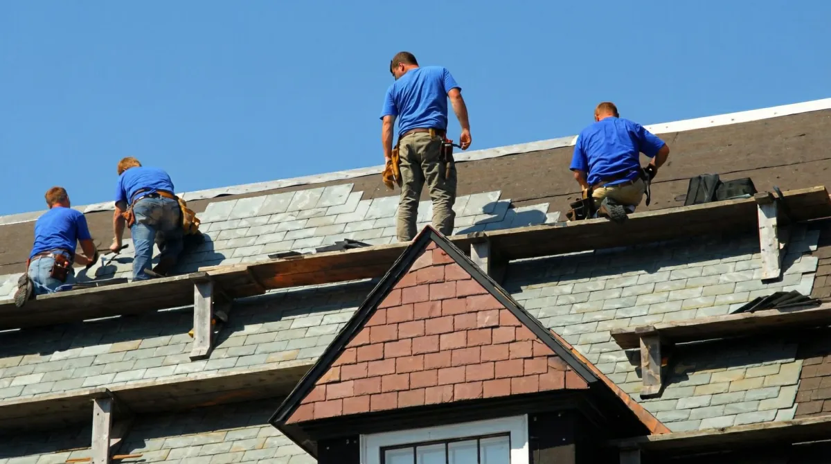 Roof replacement in progress with a team of professional contractors installing new shingles on a residential home in Cape Coral, FL